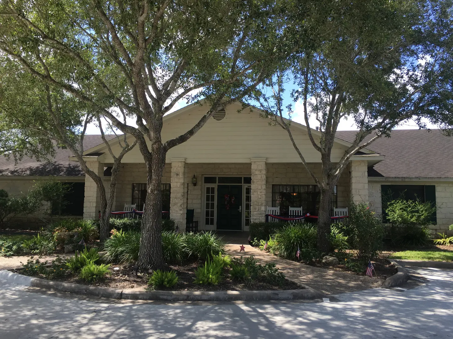 The front of a building with trees in front of it.