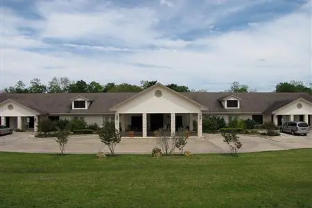 A large house with a big lawn in front of it