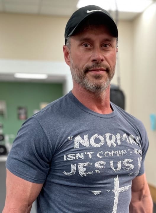 A man wearing a hat and shirt with the words " no image isn 't coming to jesus ".