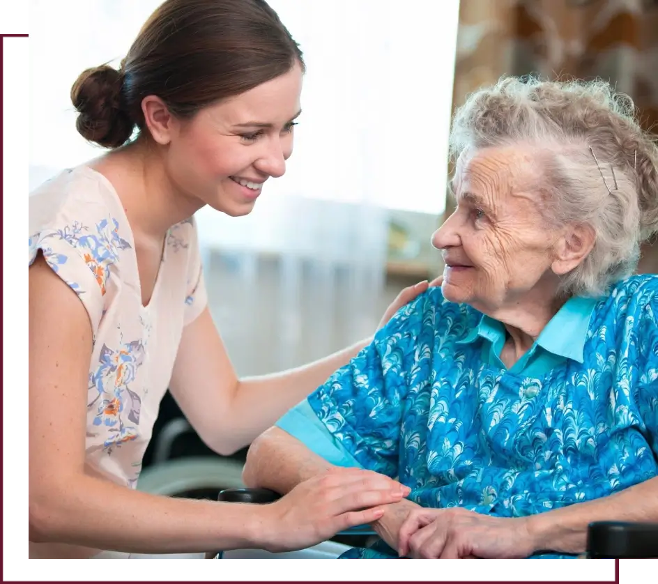 A woman and an old lady smiling for the camera.